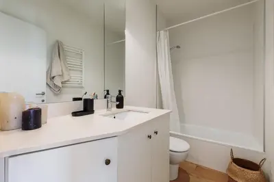 a bedroom with a large bed with two lamps at Tossa - 2 bedroom and terrace in Eixample Esquerra in Barcelona