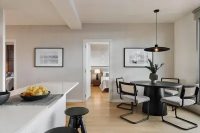 a living room with a table and a couch at Tossa - 2 bedroom and terrace in Eixample Esquerra in Barcelona