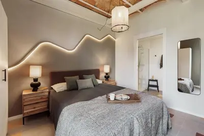 a bedroom with a bed and a potted plant at Uyuni - 2 bedrooms and balcony in Eixample Dreta in Barcelona