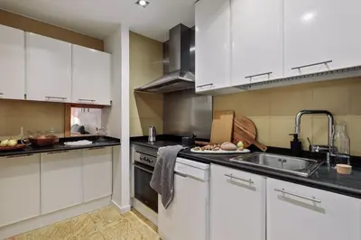 a bedroom with a bed and a chair and a window at Medes - 2 bedrooms in Sant Gervasi in Barcelona