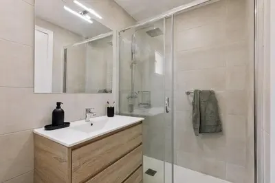 a white kitchen with white cabinets and a sink at Itza - 3 bedrooms and office and terrace in Gràcia in Barcelona