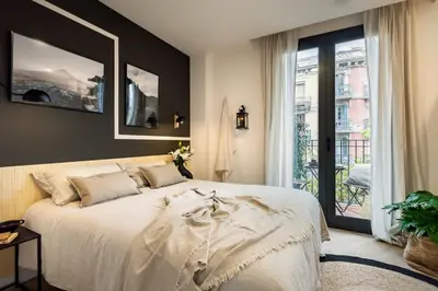 a book on a table next to a couch at Tokashi - 2 bedrooms and balcony in Eixample Dreta in Barcelona