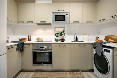 a living room with a brown leather couch at Tokashi - 2 bedrooms and balcony in Eixample Dreta in Barcelona