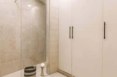 a shower with two white cabinets in a bathroom at Moumour - 2 bedrooms in Eixample Dreta in Barcelona