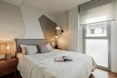 a living room with a couch and a table at Emporda - 2 bedrooms in Eixample Esquerra in Barcelona