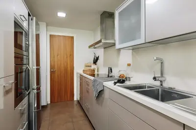 a bedroom with a large bed with two night stands and two lamps at Emporda - 2 bedrooms in Eixample Esquerra in Barcelona