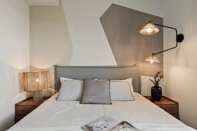 a living room with a couch and a television on a wall at Emporda - 2 bedrooms in Eixample Esquerra in Barcelona