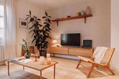a living room with a table and chairs at Casares - 1 bedroom in Gràcia in Barcelona