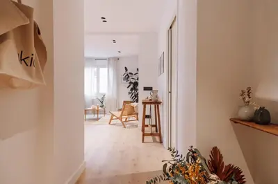 a room with a hallway with a chair and a table at Casares - 1 bedroom in Gràcia in Barcelona