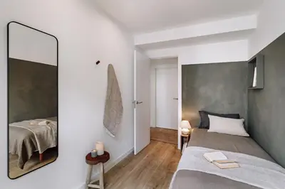 a dining room with a wooden table and a plant at Campro - 3 bedrooms w/ balcony in Eixample Esquerra in Barcelona