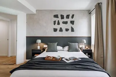 a bedroom with a large bed with a large headboard at Campro - 3 bedrooms w/ balcony in Eixample Esquerra in Barcelona