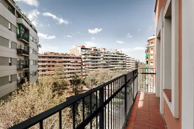 a bedroom with a large bed with shoes on the wall at Campro - 3 bedrooms w/ balcony in Eixample Esquerra in Barcelona