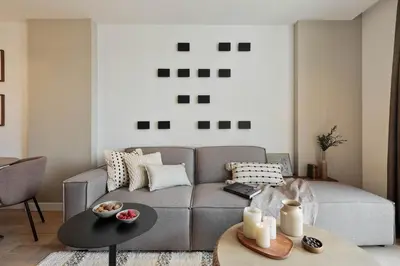 a living room with a table and chairs and a couch at Lys - 2 bedrooms and pool in Eixample Esquerra in Barcelona