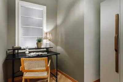 a bedroom with a bed with a green headboard at Castellar - 2 bedrooms in Eixample Dreta in Barcelona