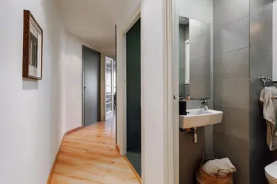 a desk and chair in a room with a window at Castellar - 2 bedrooms in Eixample Dreta in Barcelona