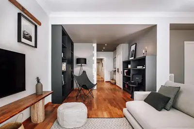 a living room with a white couch and a tv at Munia - 3 bedrooms and office in Sant Gervasi in Barcelona