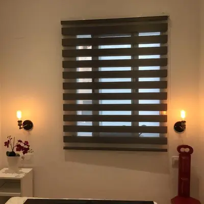 a window with a shutter in a room with lights at Apartamento CAMP NOU in Hospitalet de Llobregat
