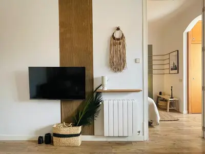 a living room with a couch and a tv at Kalo - 1 bedroom and office in Eixample Esquerra in Barcelona