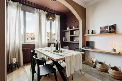 a dining room with a table and chairs and a bedroom at Kalo - 1 bedroom and office in Eixample Esquerra in Barcelona
