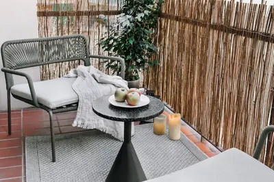 a small bedroom with a bed and a mirror at Cerler - 2 bedrooms and terrace in Sant Antoni in Barcelona