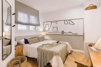 a living room with a couch and a table at Cerler - 2 bedrooms and terrace in Sant Antoni in Barcelona
