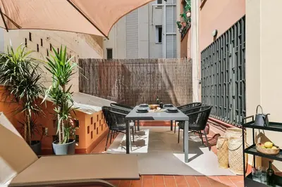 a bedroom with a bed and a living room at Oltre - 3 bedrooms in Eixample Esquerra in Barcelona