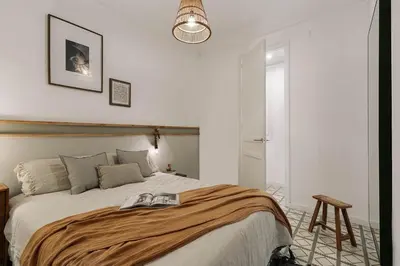 a room with a desk and a bed and a table at Oltre - 3 bedrooms in Eixample Esquerra in Barcelona