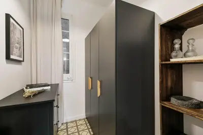 a bedroom with a large bed with a blanket on it at Oltre - 3 bedrooms in Eixample Esquerra in Barcelona