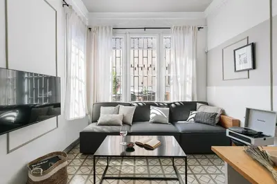 a living room with a couch and a table at Oltre - 3 bedrooms in Eixample Esquerra in Barcelona