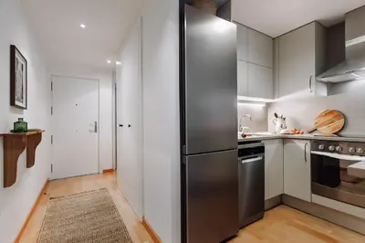 a living room with a couch and a table at Huelma - 1 bedroom and terrace in Eixample Dreta in Barcelona