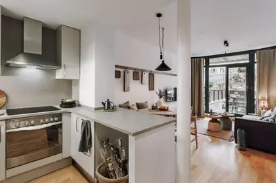 a kitchen with a stainless steel refrigerator at Huelma - 1 bedroom and terrace in Eixample Dreta in Barcelona