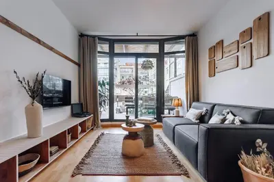 a kitchen and living room with a table and chairs at Huelma - 1 bedroom and terrace in Eixample Dreta in Barcelona