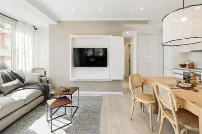 a kitchen with white cabinets and a wooden table at Ona - 2 bedrooms in Sant Gervasi in Barcelona
