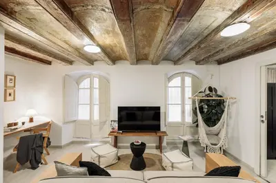 a bedroom with a large white bed with two lamps at Sitges - 2 bedrooms in St Pere Sta Caterina i Ribera in Barcelona