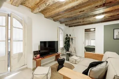 a bedroom with a bed with a green blanket on it at Sitges - 2 bedrooms in St Pere Sta Caterina i Ribera in Barcelona
