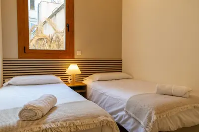 two beds in a room with a window at 