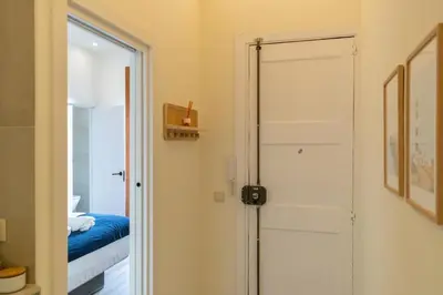 a door leading to a bedroom with a bed at 