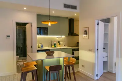 a kitchen with green cabinets and a table and chairs at 