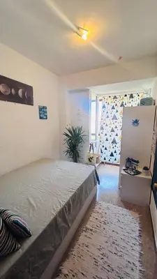a bedroom with a bed in a room with a window at Alojamiento,Les corts in Barcelona