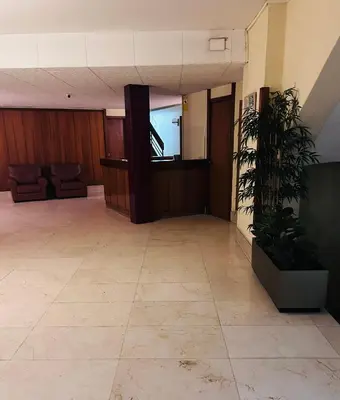 an empty lobby with a television in a building at Alojamiento,Les corts in Barcelona