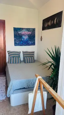 a bedroom with a bed with two pillows at Alojamiento,Les corts in Barcelona