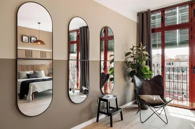 a bedroom with a bed with two lamps and a vase on the wall at Tilapa - 2 bedrooms and terrace in Sant Antoni in Barcelona