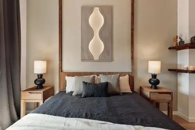 a bedroom with a large bed and a mirror at Tilapa - 2 bedrooms and terrace in Sant Antoni in Barcelona