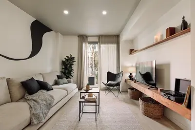 a living room with a couch and a tv at Hebron - 2 bedrooms and office in Gràcia in Barcelona