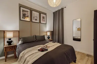 a dining room with a table and a couch at Takalik - 4 bedrooms and office in l'Eixample Esq. in Barcelona