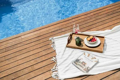 a table with a plate of fruit and a glass of wine at Paul - 2 bedrooms and pool in Poblenou in Barcelona