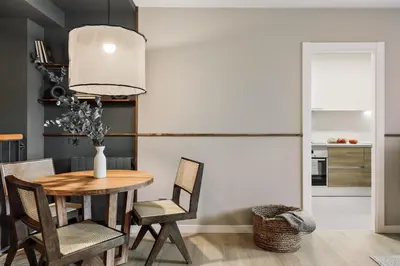 a living room with a table and chairs and a couch at Paul - 2 bedrooms and pool in Poblenou in Barcelona