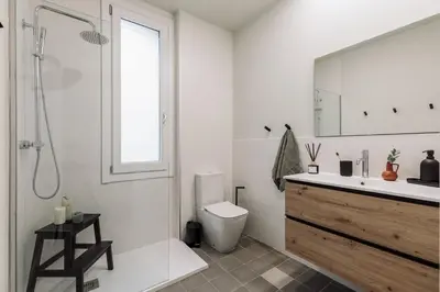 a bedroom with a bed and a desk and a television at Pollock - 2 bedrooms and office in Eixample Dreta in Barcelona
