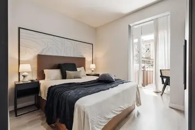 a living room with a flat screen tv on a wall at Acconci - Studio and terrace in Eixample Esquerra in Barcelona