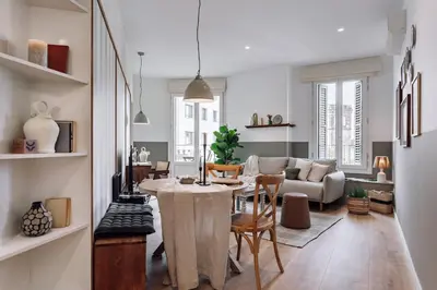 a wooden table with a vase and candles on it at Montoro - 1 bedroom in Eixample Esquerra in Barcelona